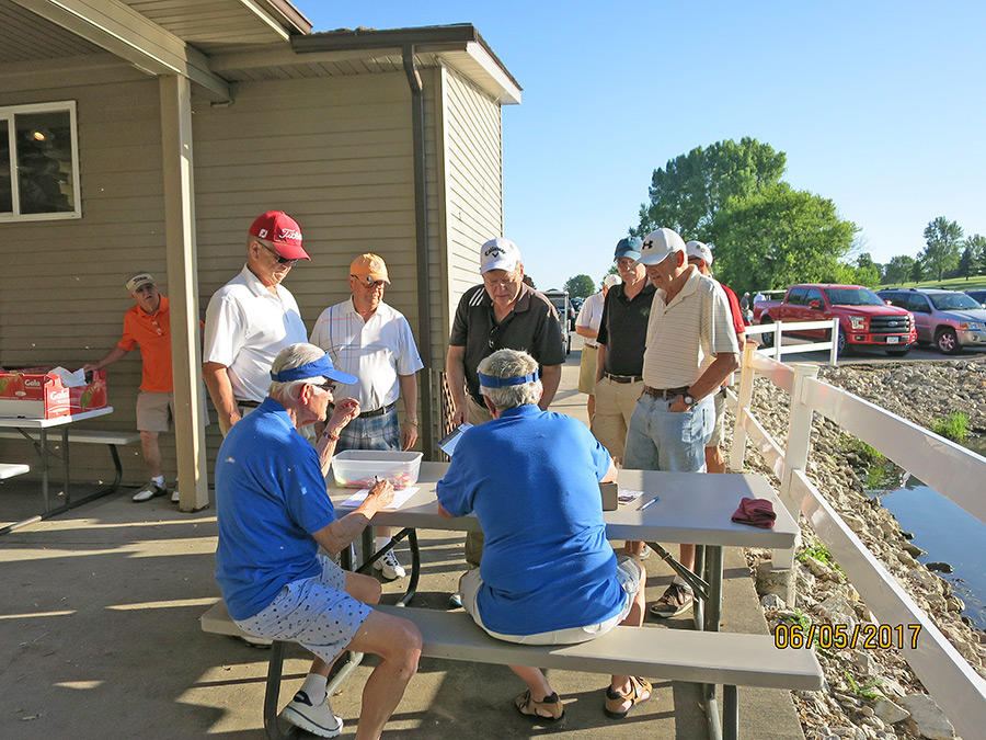 Lou Twillman and Bill Wohlford check golfers in for the golf outing.