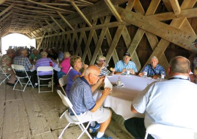 Trailways trip to Winterset and the Bridges of Madison County, IA. Having lunch on the Roseman Covered Bridge.